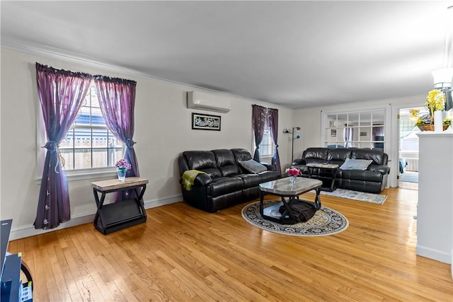 15 Broadmoor Rd, Cranston, RI 02910 - living area featuring a healthy amount of sunlight, radiator, a wall mounted AC, and hardwood / wood-style flooring