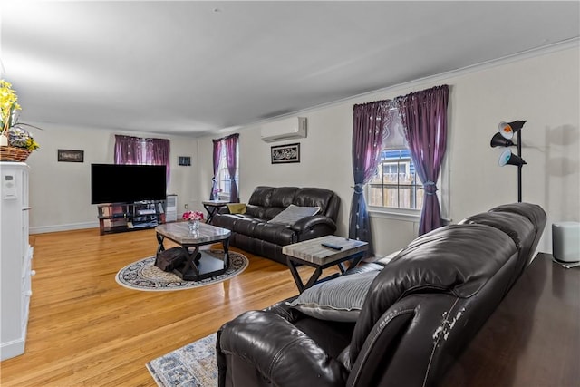 15 Broadmoor Rd, Cranston, RI 02910 - living area featuring baseboards, a wall mounted AC, a healthy amount of sunlight, and wood finished floors