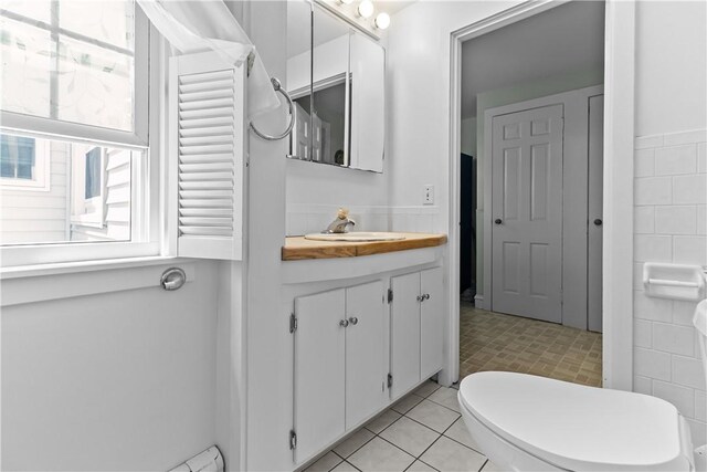 15 Broadmoor Rd, Cranston, RI 02910 - bathroom featuring tile walls, a baseboard radiator, and vanity