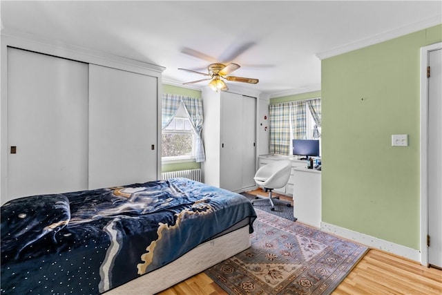 15 Broadmoor Rd, Cranston, RI 02910 - bedroom featuring radiator heating unit, multiple closets, ornamental molding, and multiple windows