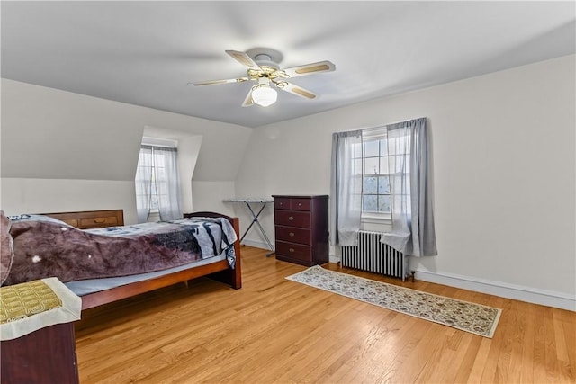 15 Broadmoor Rd, Cranston, RI 02910 - bedroom with baseboards, radiator, ceiling fan, and wood finished floors