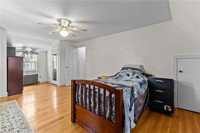 15 Broadmoor Rd, Cranston, RI 02910 - bedroom featuring radiator heating unit, baseboards, light wood-style floors, and a ceiling fan