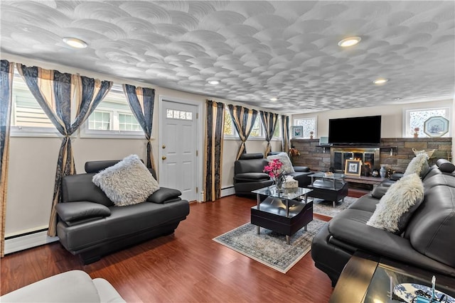 15 Broadmoor Rd, Cranston, RI 02910 - living room with recessed lighting, a baseboard heating unit, a glass covered fireplace, and a wealth of natural light