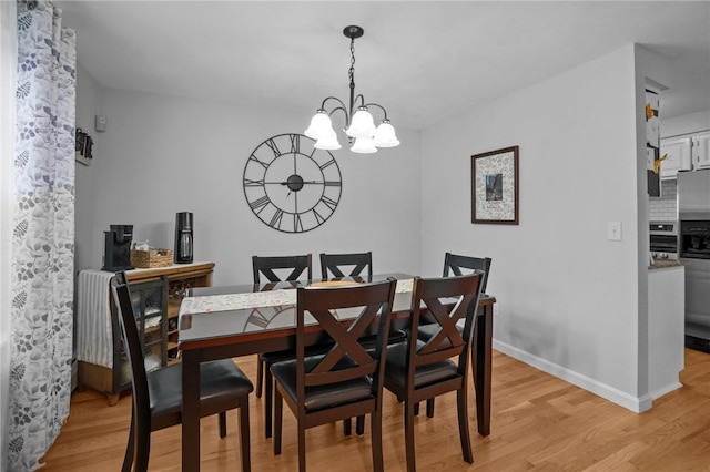 60 Hawthorne Pl Unit 23, North Providence, RI 02904 - dining area featuring baseboards, an inviting chandelier, and light wood-style floors