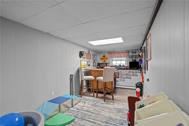 60 Hawthorne Pl Unit 23, North Providence, RI 02904 - recreation room with a decorative wall, a drop ceiling, and baseboard heating