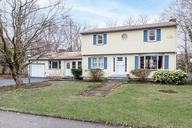 180 Birkshire Dr, Warwick, RI 02886 - colonial-style house featuring a chimney, driveway, and a front yard