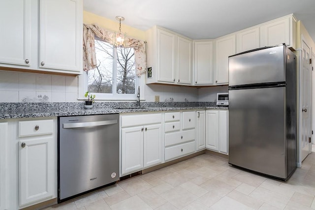 180 Birkshire Dr, Warwick, RI 02886 - kitchen featuring a sink, light stone counters, decorative backsplash, and stainless steel appliances