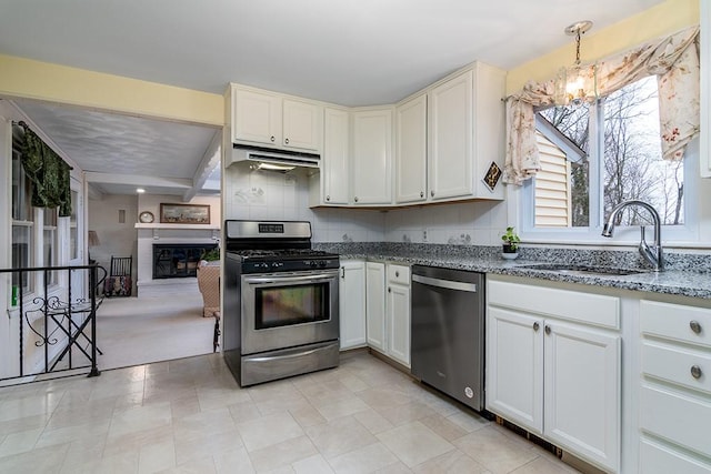 180 Birkshire Dr, Warwick, RI 02886 - kitchen featuring a sink, a chandelier, stainless steel appliances, stone counters, and under cabinet range hood