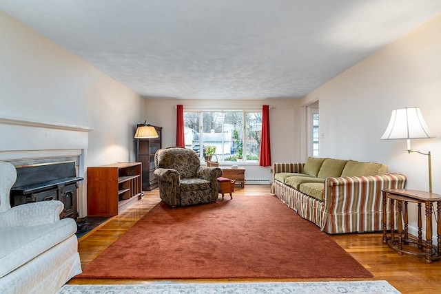 180 Birkshire Dr, Warwick, RI 02886 - living area featuring a fireplace with flush hearth, baseboard heating, and wood finished floors