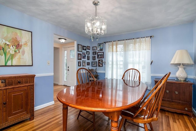 180 Birkshire Dr, Warwick, RI 02886 - dining space featuring baseboards, a chandelier, a healthy amount of sunlight, and light wood-style floors