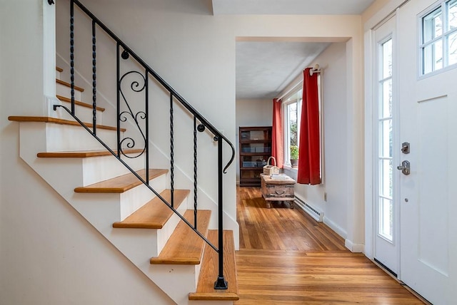 180 Birkshire Dr, Warwick, RI 02886 - entrance foyer with baseboards, baseboard heating, stairs, and wood finished floors