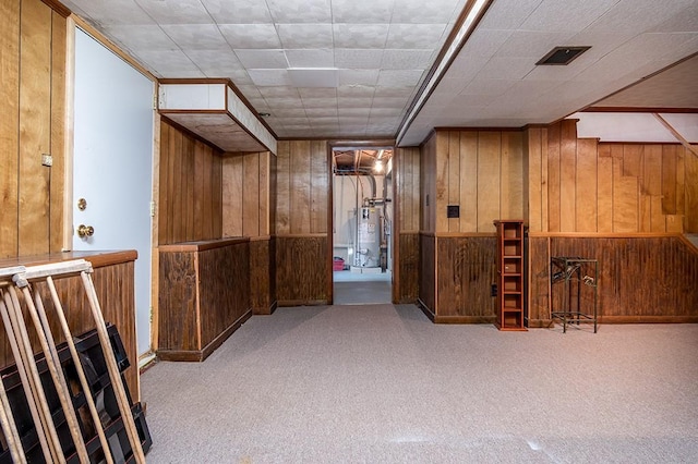 180 Birkshire Dr, Warwick, RI 02886 - finished below grade area featuring visible vents, wood walls, water heater, and carpet flooring