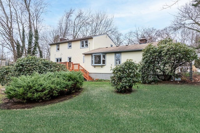 180 Birkshire Dr, Warwick, RI 02886 - back of house featuring a lawn, a chimney, stairs, and a wooden deck