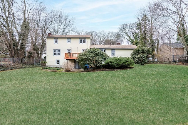 180 Birkshire Dr, Warwick, RI 02886 - back of house featuring fence, a wooden deck, a chimney, and a lawn
