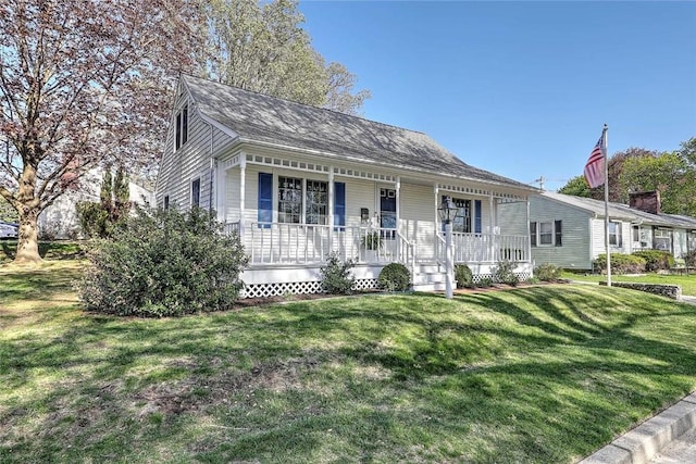 view of front of house featuring covered porch and a front yard