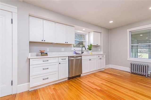 888 Providence St, West Warwick, RI 02893 - kitchen with a sink, dishwasher, radiator heating unit, and light countertops