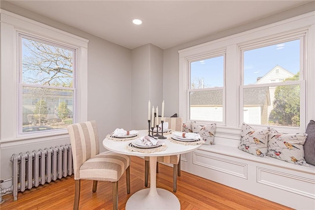 888 Providence St, West Warwick, RI 02893 - dining space featuring recessed lighting, plenty of natural light, radiator heating unit, and light wood-style flooring