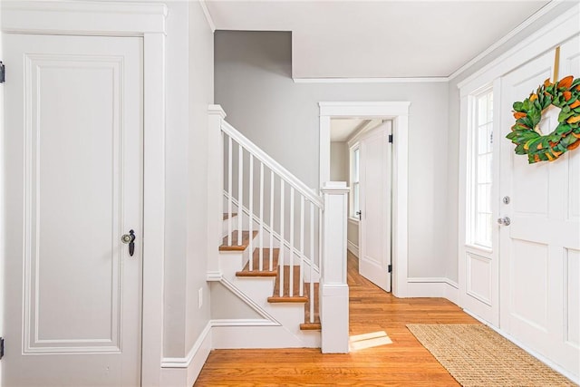 888 Providence St, West Warwick, RI 02893 - entryway featuring baseboards, stairway, and light wood-type flooring