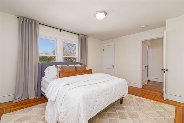 888 Providence St, West Warwick, RI 02893 - bedroom with light wood-style floors and baseboards