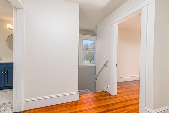 888 Providence St, West Warwick, RI 02893 - hall featuring baseboards, wood finished floors, and an upstairs landing