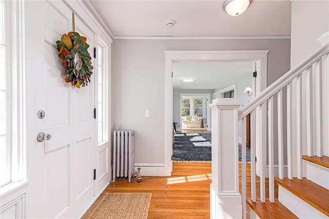 888 Providence St, West Warwick, RI 02893 - foyer entrance with stairway, radiator, ornamental molding, and light wood finished floors