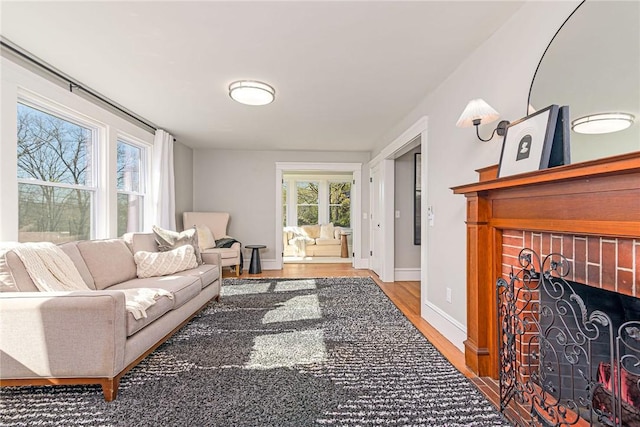 888 Providence St, West Warwick, RI 02893 - living area with baseboards, wood finished floors, and a fireplace