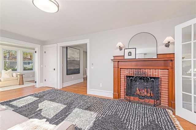 888 Providence St, West Warwick, RI 02893 - living area with baseboards, wood finished floors, and a fireplace