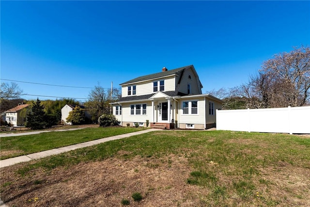 888 Providence St, West Warwick, RI 02893 - view of front facade with a gambrel roof, a front lawn, fence, and a chimney