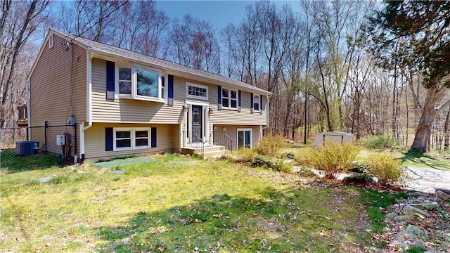 108 Shady Lea Rd, North Kingstown, RI 02852 - split foyer home featuring fence, a storage shed, a front yard, an outbuilding, and central air condition unit