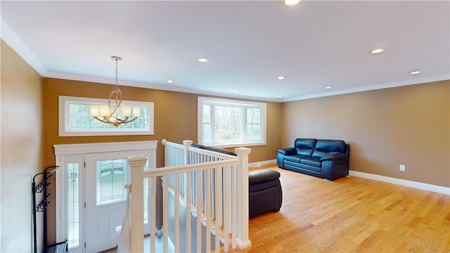108 Shady Lea Rd, North Kingstown, RI 02852 - entrance foyer with crown molding, baseboards, an inviting chandelier, and light wood-type flooring