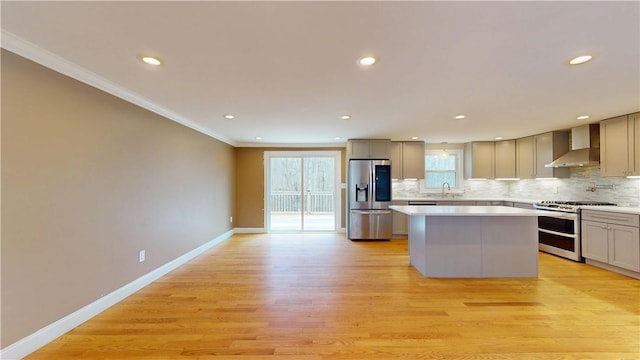 108 Shady Lea Rd, North Kingstown, RI 02852 - kitchen featuring crown molding, a kitchen island, wall chimney range hood, backsplash, and stainless steel appliances