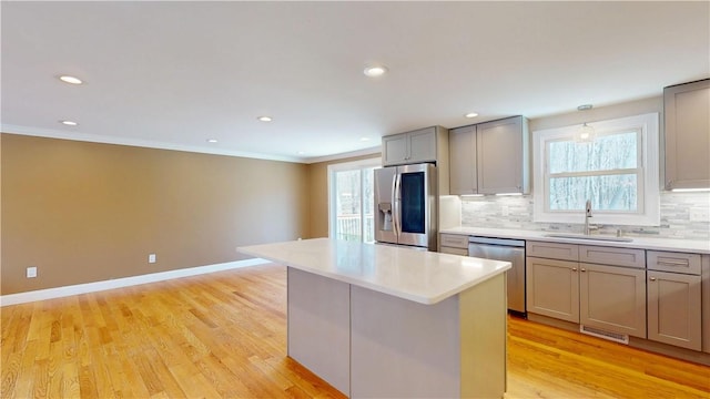 108 Shady Lea Rd, North Kingstown, RI 02852 - kitchen with a sink, appliances with stainless steel finishes, gray cabinets, and decorative backsplash