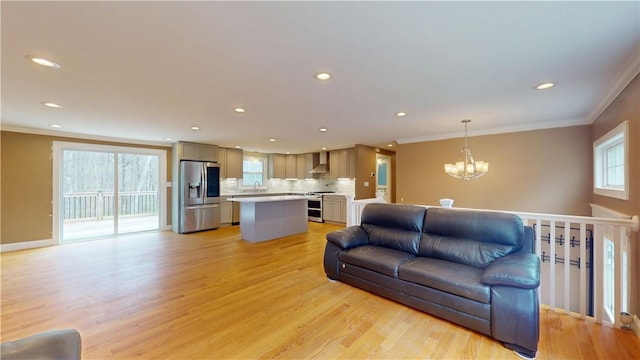 108 Shady Lea Rd, North Kingstown, RI 02852 - living area with an inviting chandelier, ornamental molding, light wood-style floors, and recessed lighting