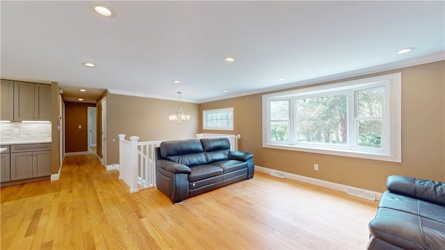 108 Shady Lea Rd, North Kingstown, RI 02852 - living area with visible vents, ornamental molding, baseboards, and a notable chandelier