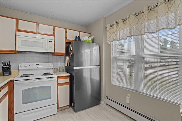 kitchen with white appliances, a baseboard heating unit, tasteful backsplash, and light countertops