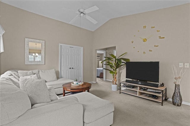 carpeted living room with a ceiling fan, baseboards, and vaulted ceiling