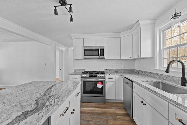 87 Elmbrook Dr, Warwick, RI 02889 - kitchen with white cabinets, appliances with stainless steel finishes, a sink, and dark wood finished floors