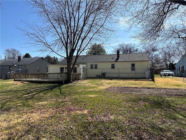 87 Elmbrook Dr, Warwick, RI 02889 - rear view of house with a chimney, a yard, a deck, and cooling unit