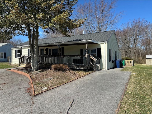 87 Elmbrook Dr, Warwick, RI 02889 - view of front of house featuring a shingled roof, a front lawn, covered porch, and driveway