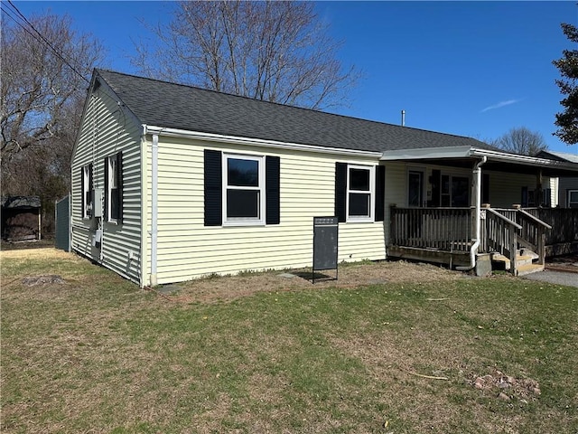87 Elmbrook Dr, Warwick, RI 02889 - view of front of house with roof with shingles, covered porch, and a front yard