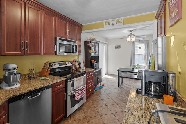 70 Perkins Ave, Cranston, RI 02910 - kitchen with ceiling fan, light tile patterned floors, dark brown cabinets, and stainless steel appliances