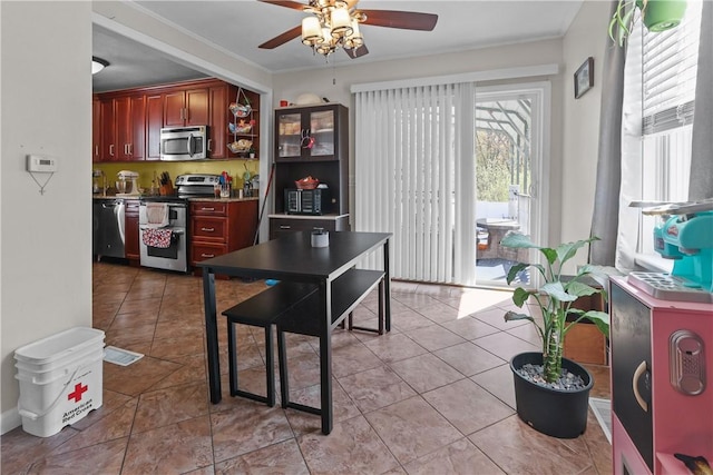 70 Perkins Ave, Cranston, RI 02910 - kitchen featuring ornamental molding, light tile patterned flooring, dark brown cabinets, a ceiling fan, and stainless steel appliances