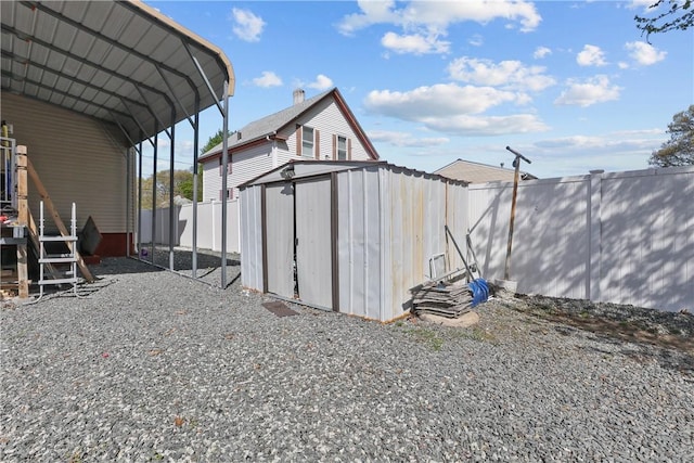 70 Perkins Ave, Cranston, RI 02910 - view of shed with a fenced backyard, a detached carport, and driveway