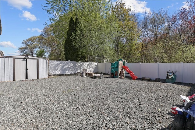 70 Perkins Ave, Cranston, RI 02910 - view of yard with a storage unit, a fenced backyard, a playground, and an outdoor structure