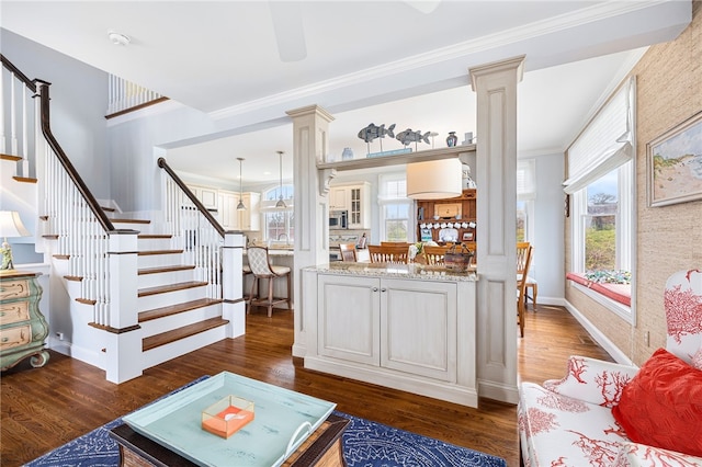 244 Spring St, Block Island, RI 02807 - living area featuring ornate columns, stairs, and dark wood finished floors