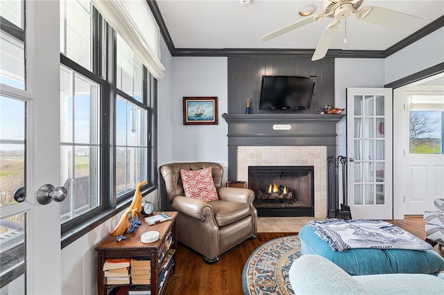244 Spring St, Block Island, RI 02807 - living room with crown molding, a ceiling fan, wood finished floors, and a tiled fireplace