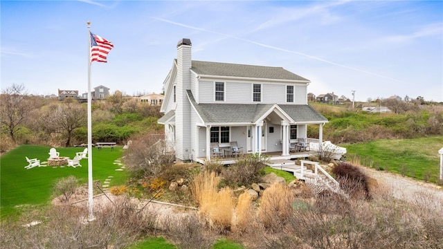 244 Spring St, Block Island, RI 02807 - view of front facade with a porch, a shingled roof, a front lawn, and a chimney