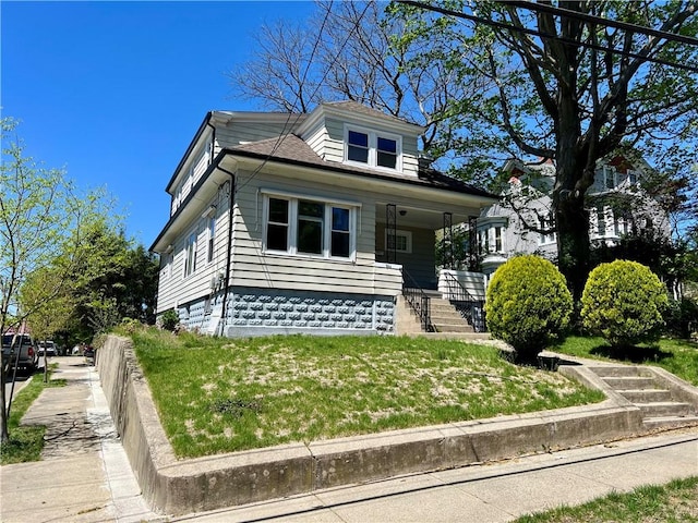 bungalow-style house featuring a porch, fence, and a front yard
