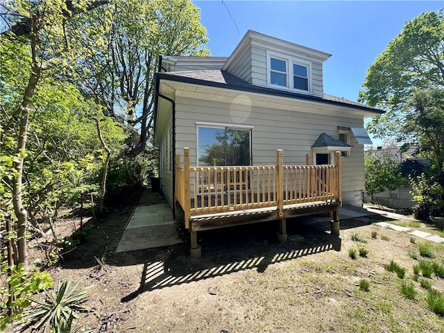 back of house with a deck