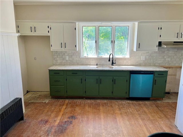 kitchen with decorative backsplash, dishwashing machine, and green cabinetry